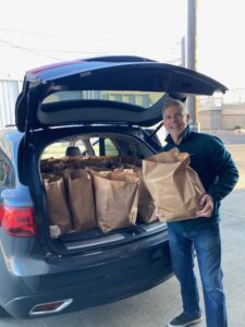 Mark pictured loading up his car with 60 bags, preparing to deliver them to residents at Miley Gardens, Loro Landing and EE Cleveland.