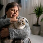 Senior woman holding cat
